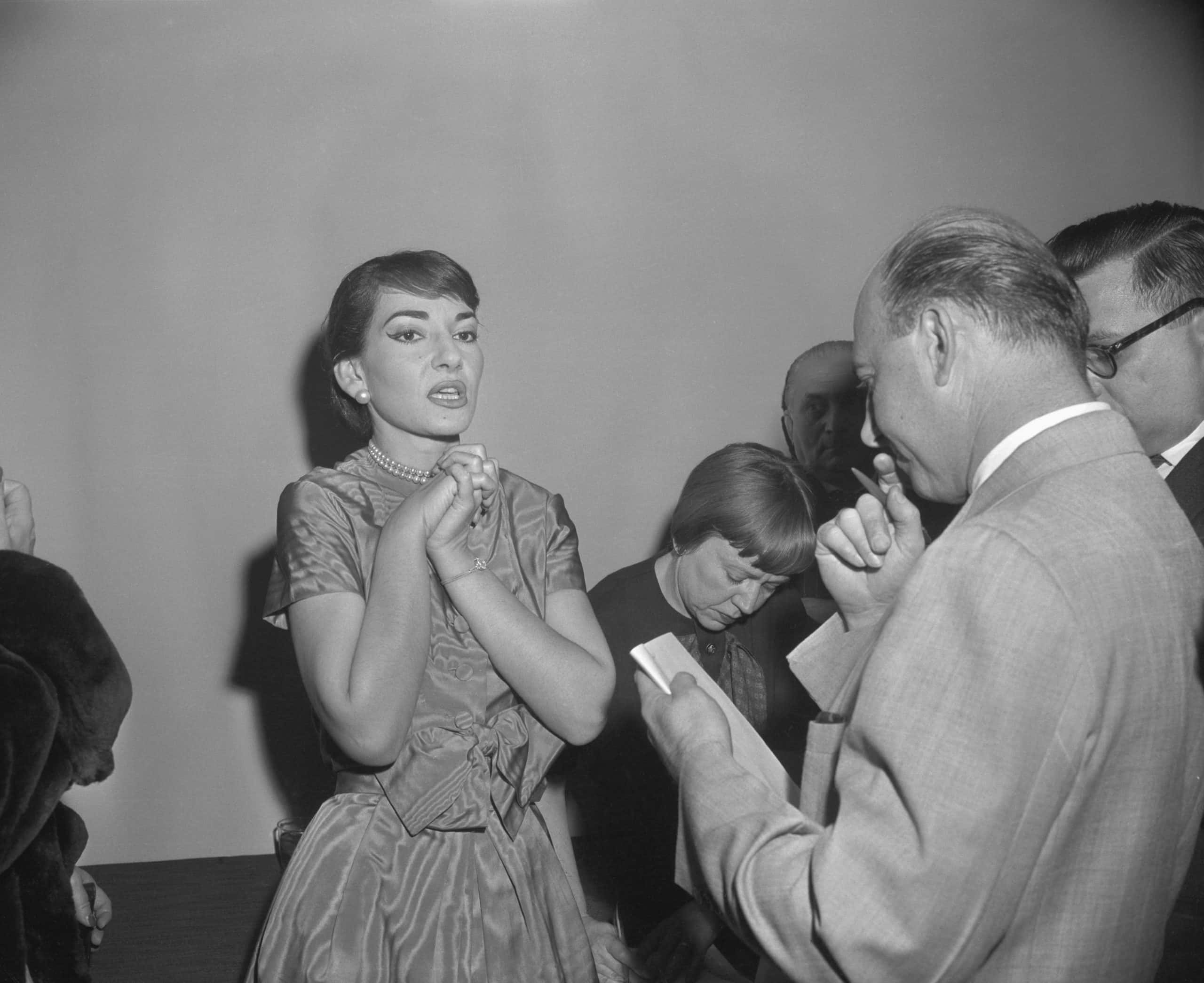 Opera Star Maria Callas Speaking to Reporter with her palms crossed