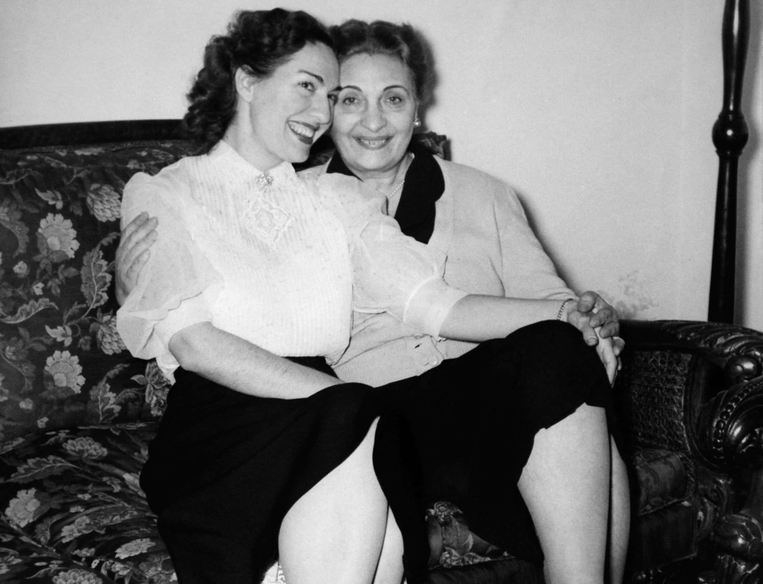 Grayscale Portrait Photo of Mari Callas and her mother, sitting on a couch, hugging each other