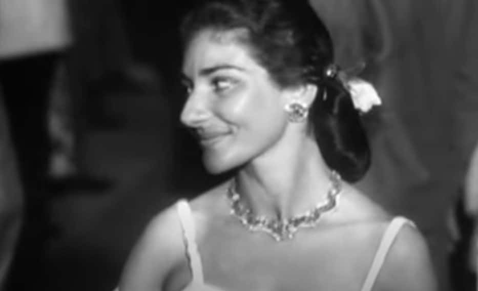 Grayscale Portrait Photo of Maria Callas wearing a white dress, looking to the left