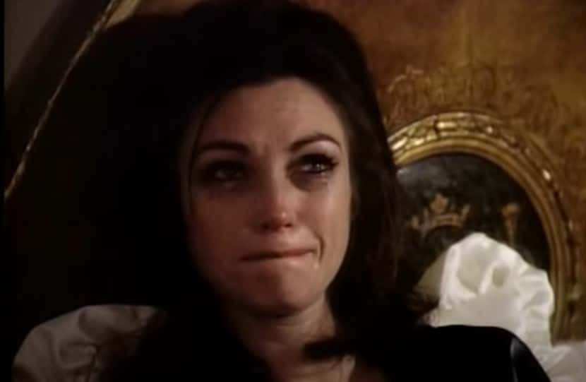 Portrait Photo depicting Maria Callas wearing a black dress, crying, facing the camera