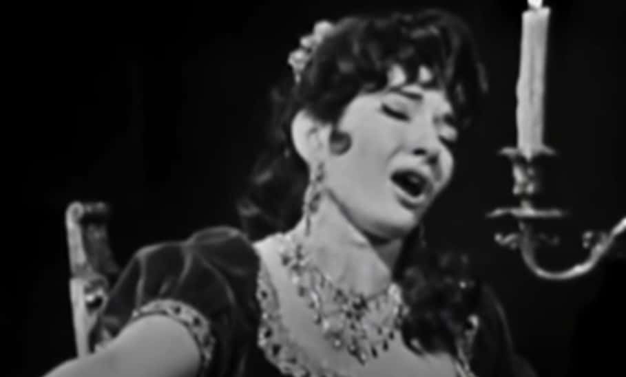 Grayscale Portrait Photo of Maria Callas wearing a black dress, performing on a stage