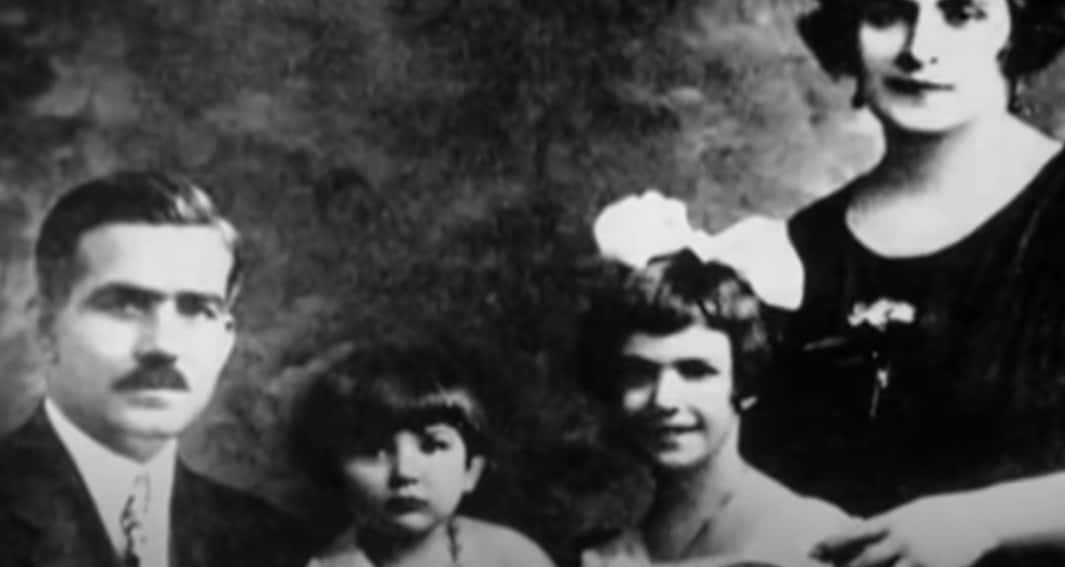 Grayscale Photo of child Maria her mother, father and her sister standing next to each other