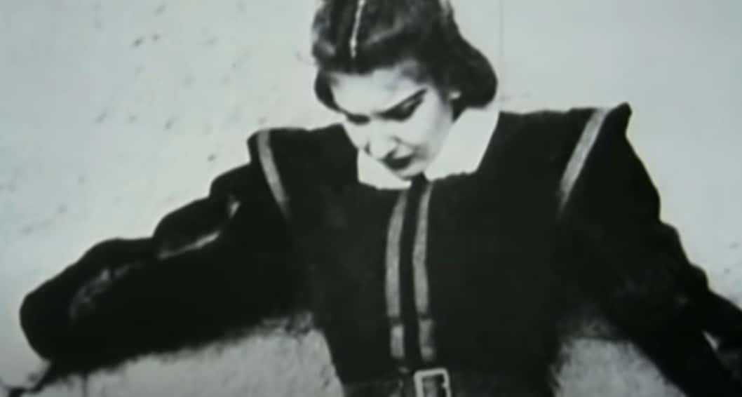 Grayscale Portrait Photo of Maria Callas wearing a black dress, looking downwards