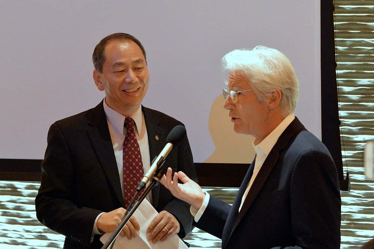 Portrait Photo of Lobsang Nyandak and Richard Gere on a blurred background