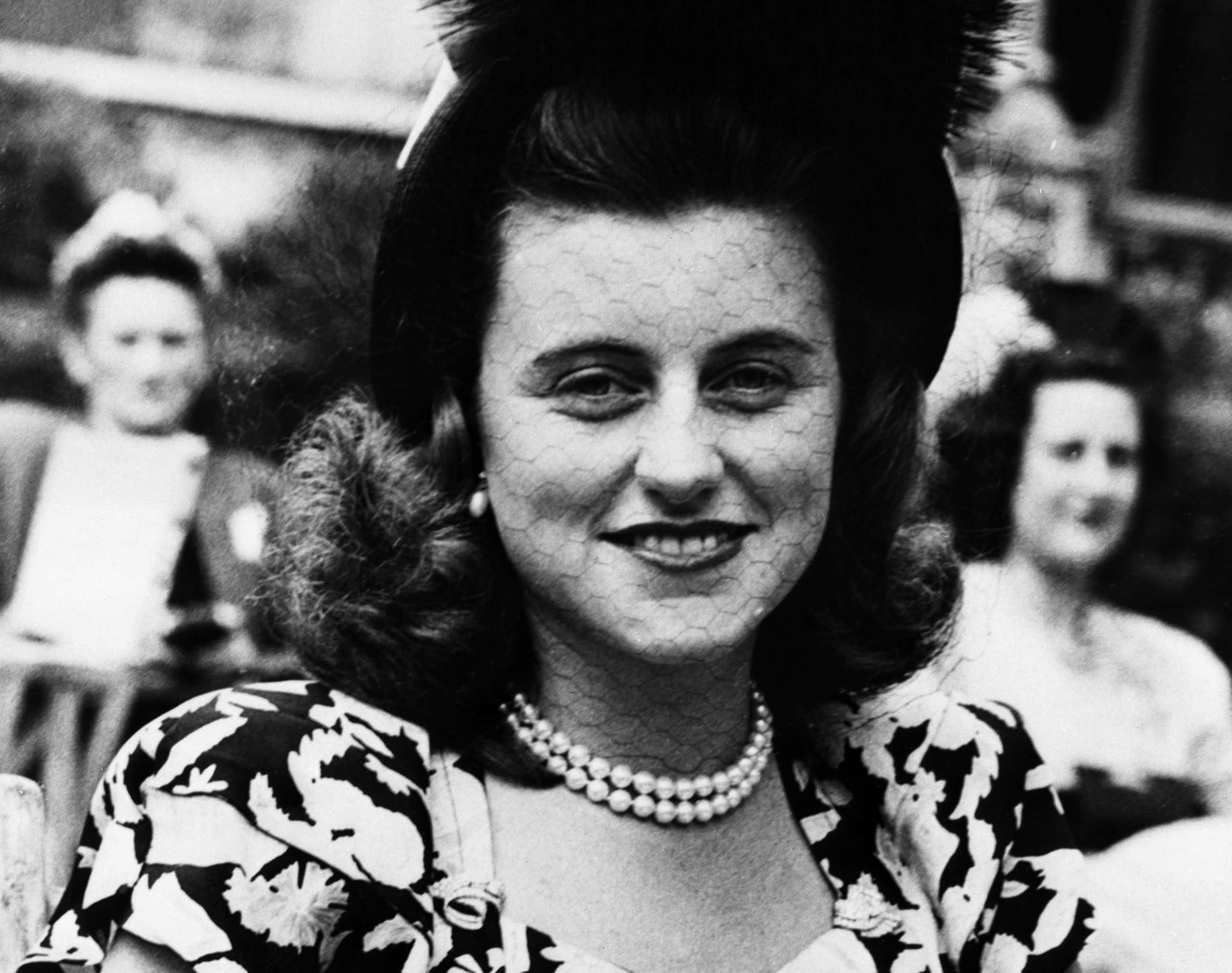 Kathleen Cavendish in patterned dress and hat