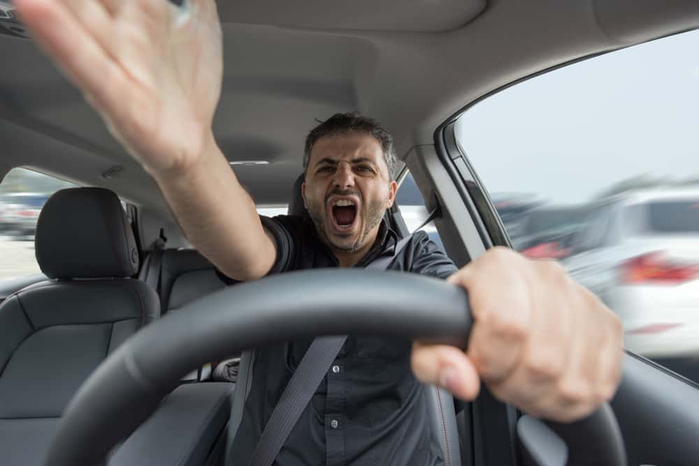 Angry man yelling in car.