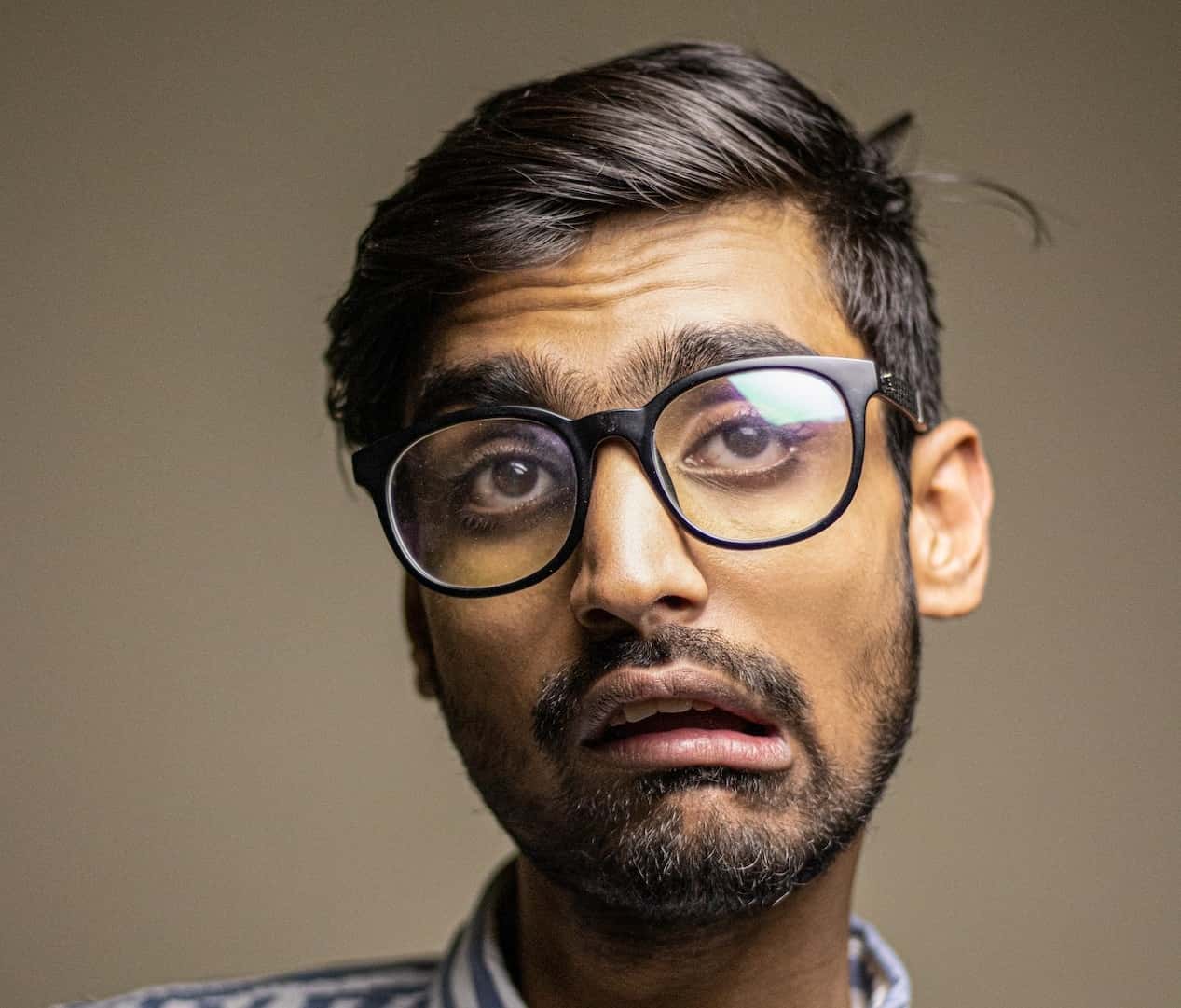 Man with glasses thinking.