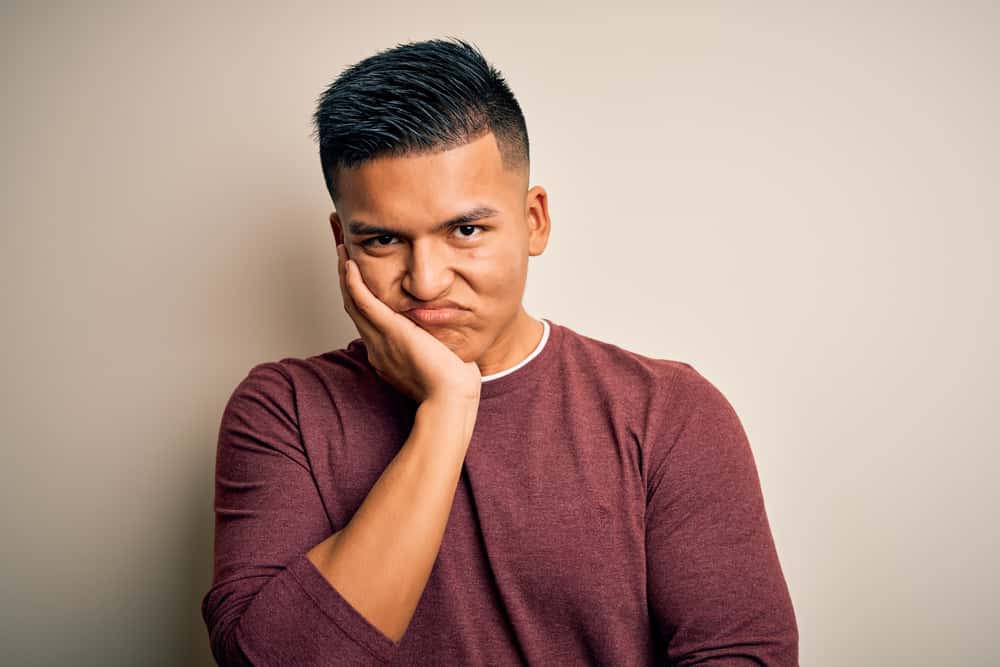 Young handsome latin man thinking