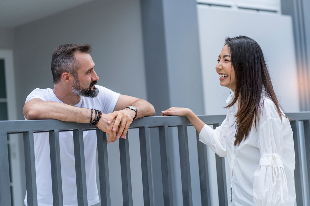 female neighbor walks to say hello to a male neighbor