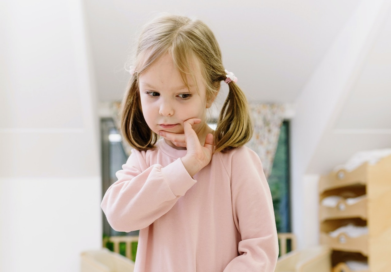 Kid thinking and looking down.