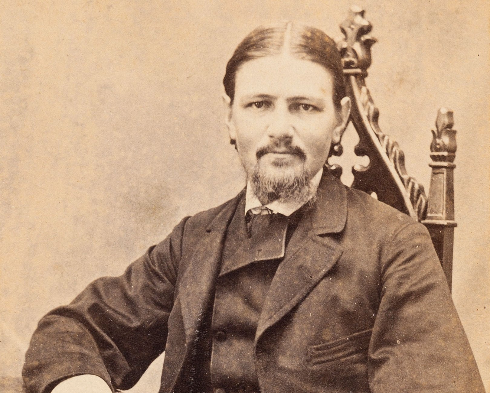 Portrait of Boston Corbett in 1865 seated in a Gothic chair