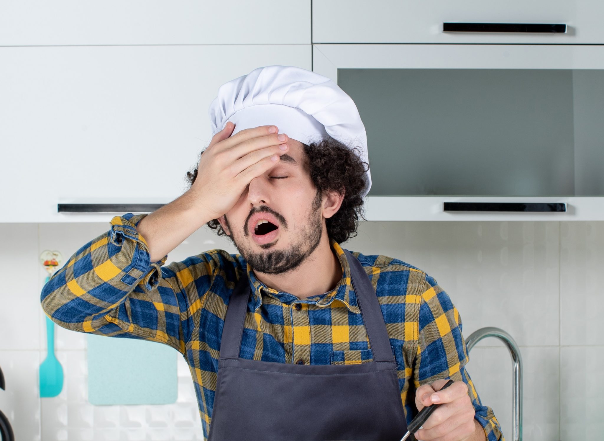 Confused man in kitchen