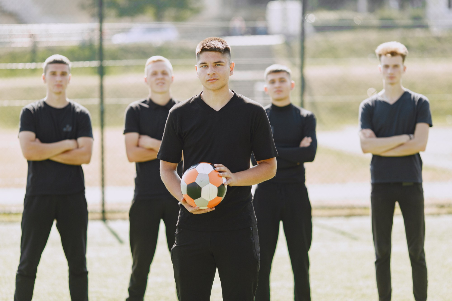 Team play football at the park