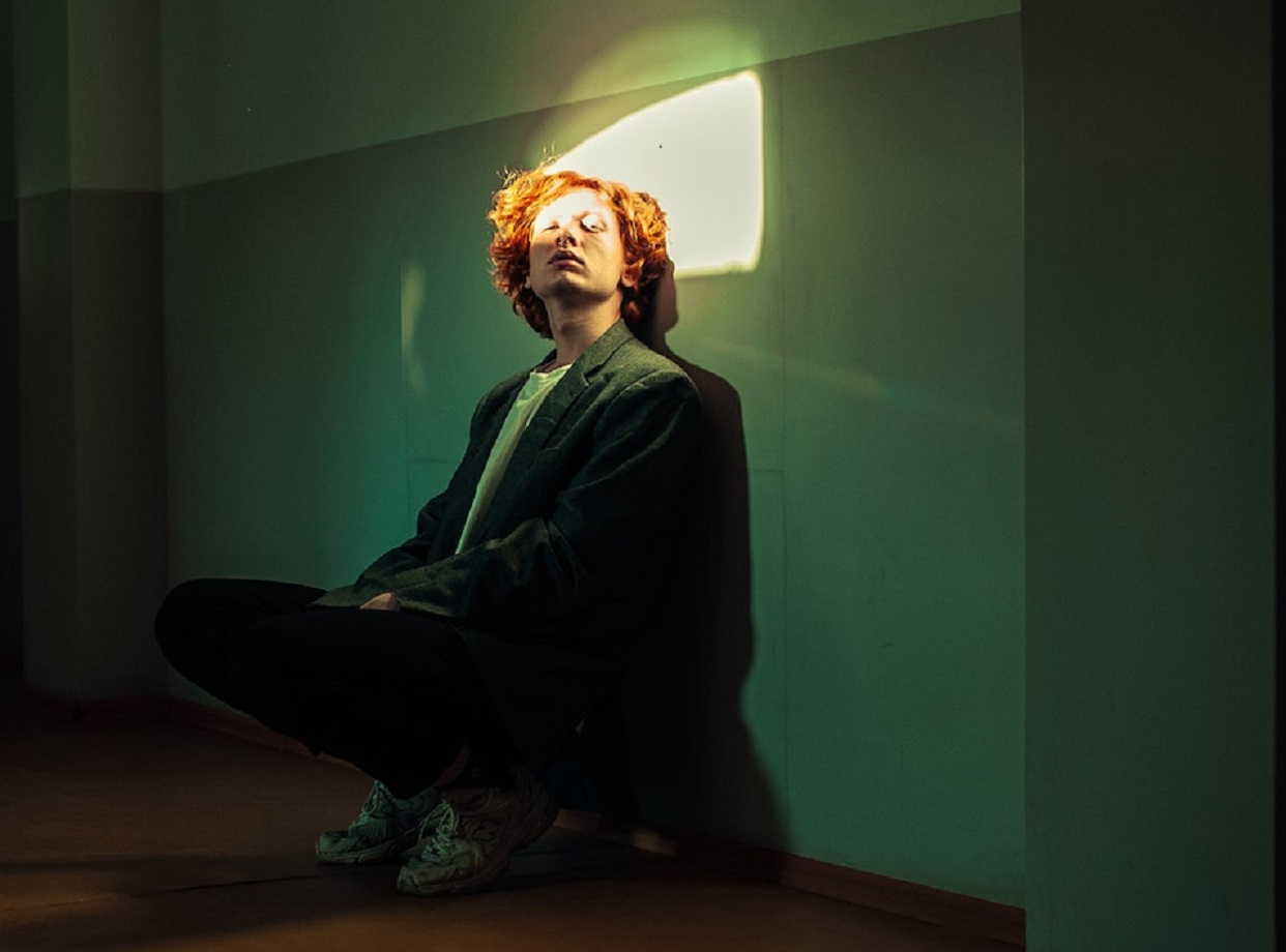 Man seating in a dark room