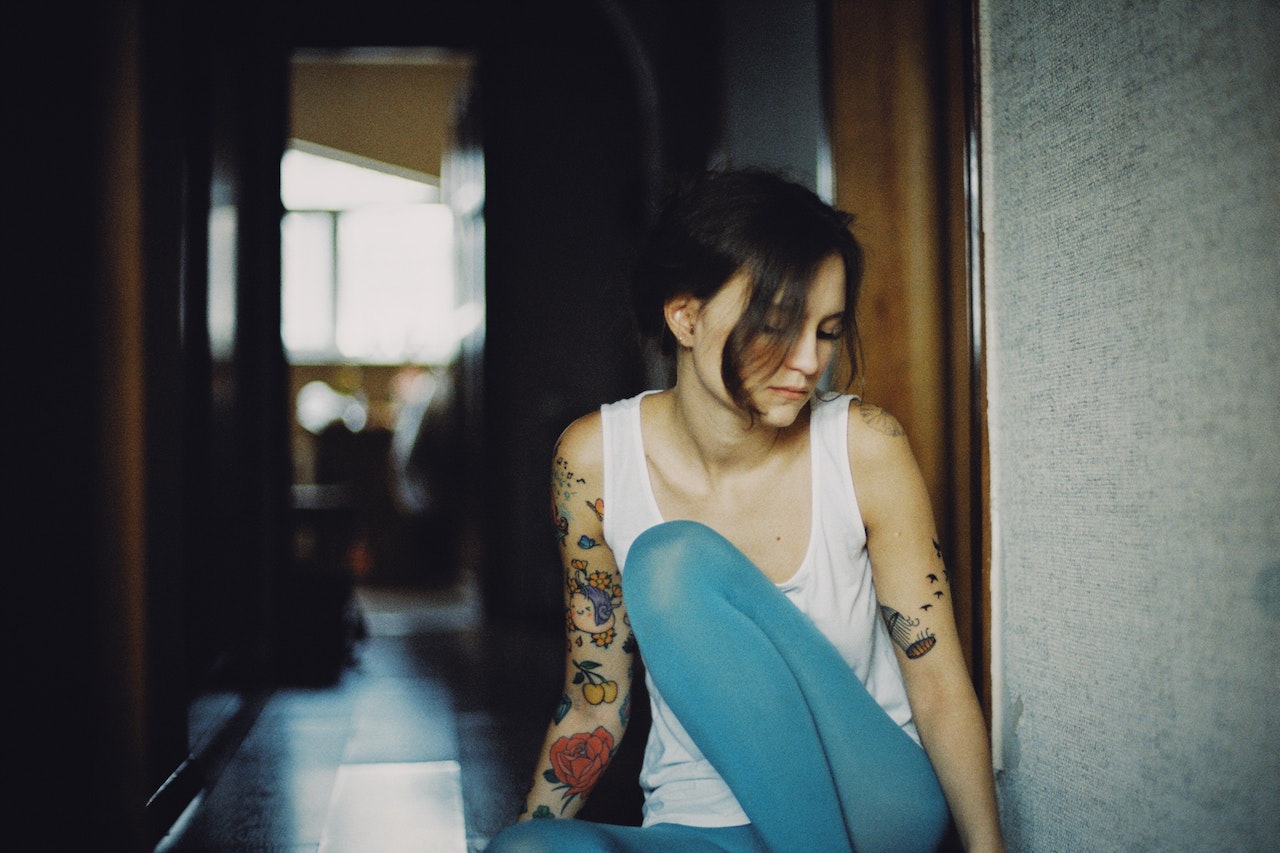 Sad tattooed woman