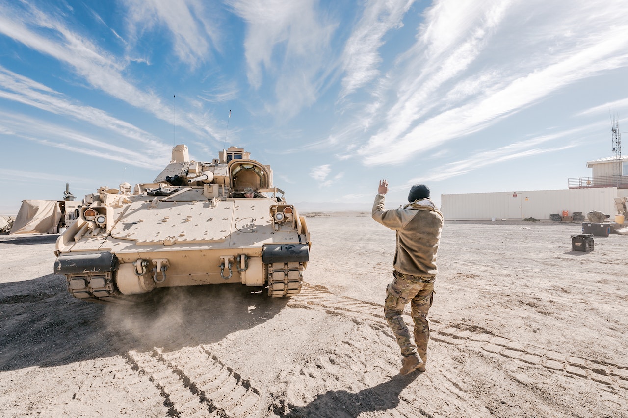 Man in front of a army tank