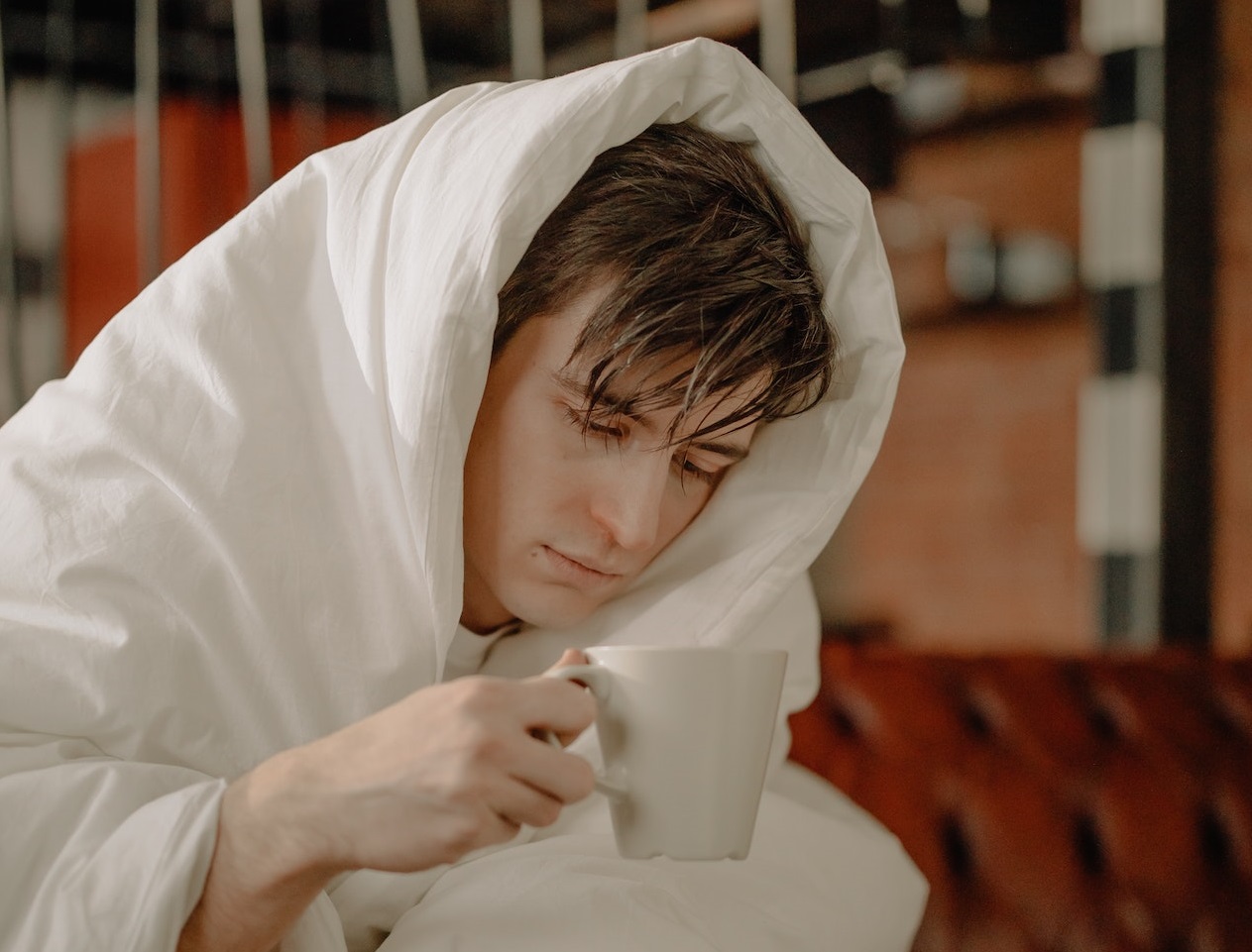 Sick man drinking tea