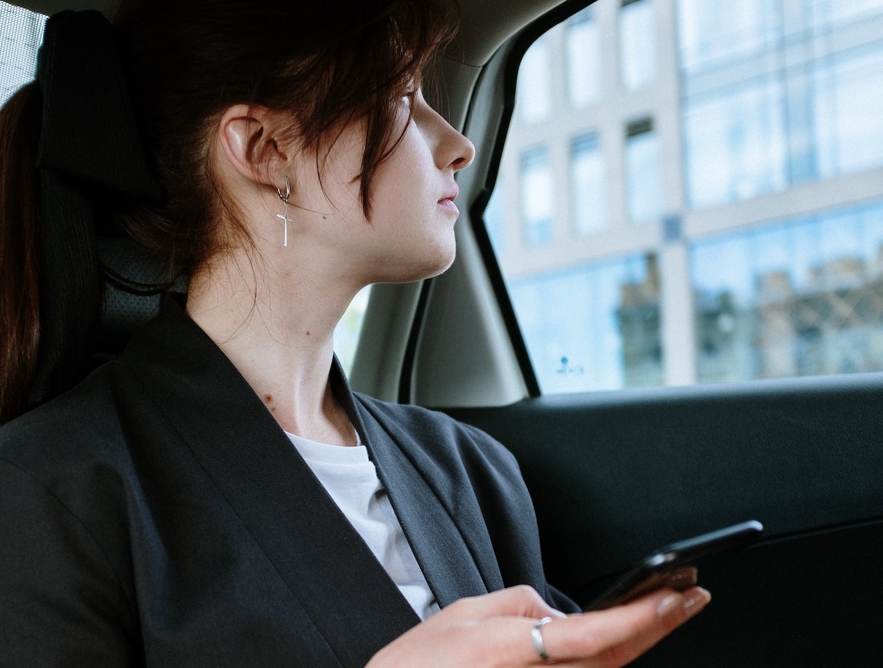 Woman with phone at taxi.