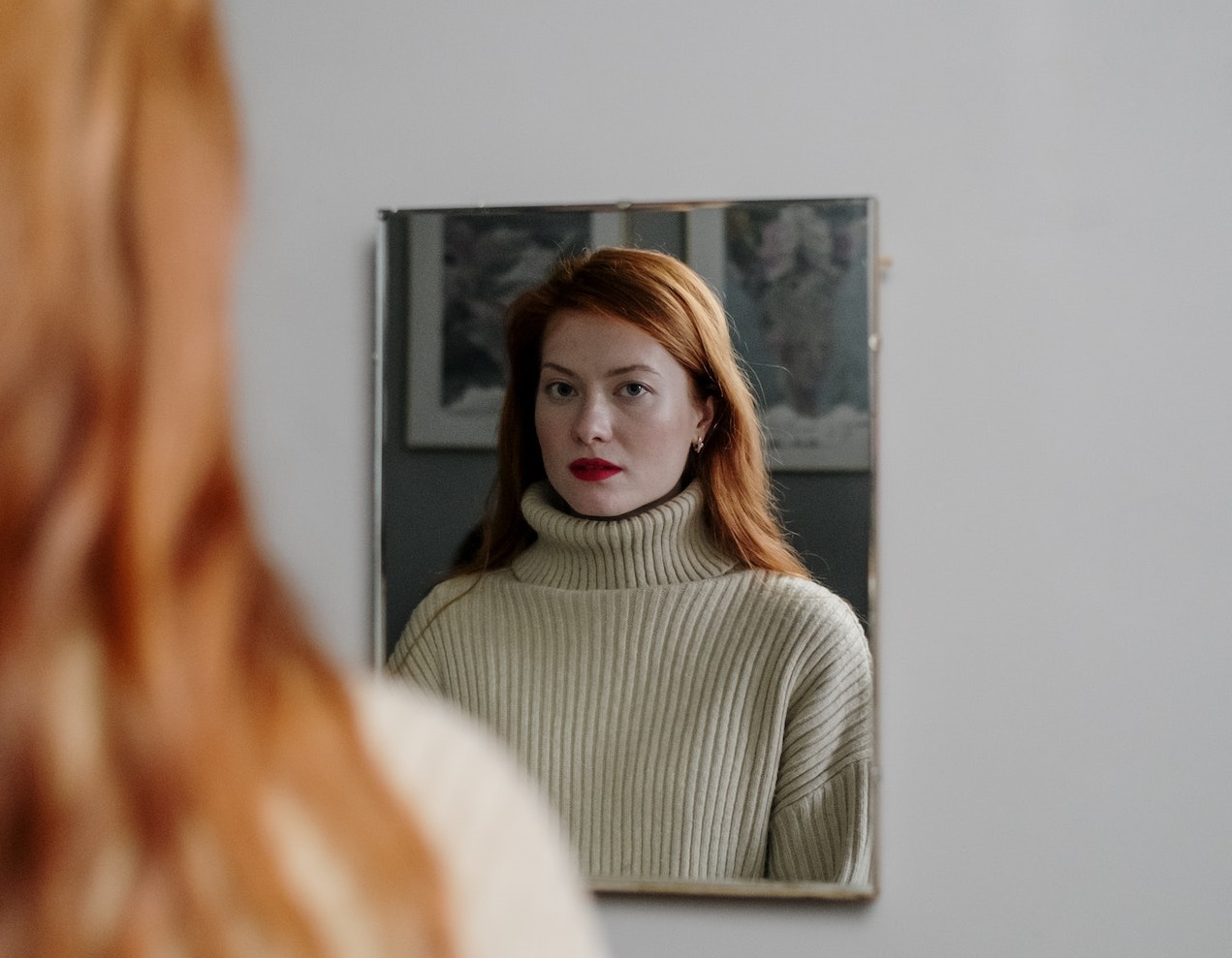 woman looking on the mirror