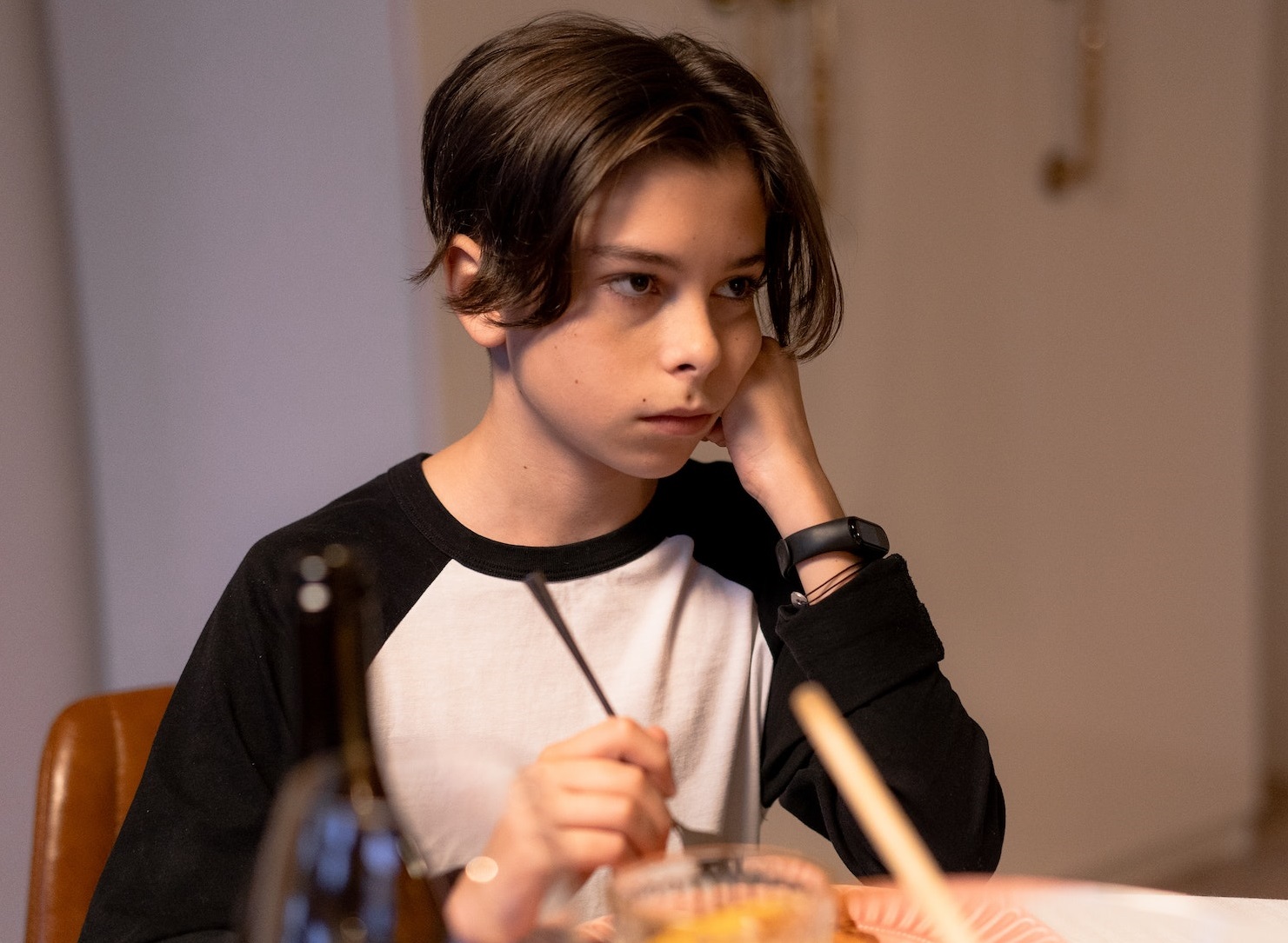 Sad kid at dinner table