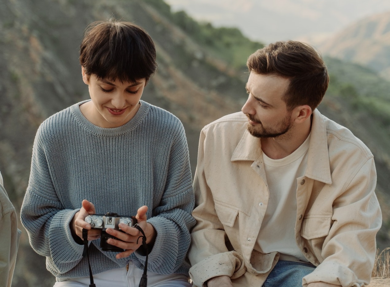 Couple watching photos on camera screen