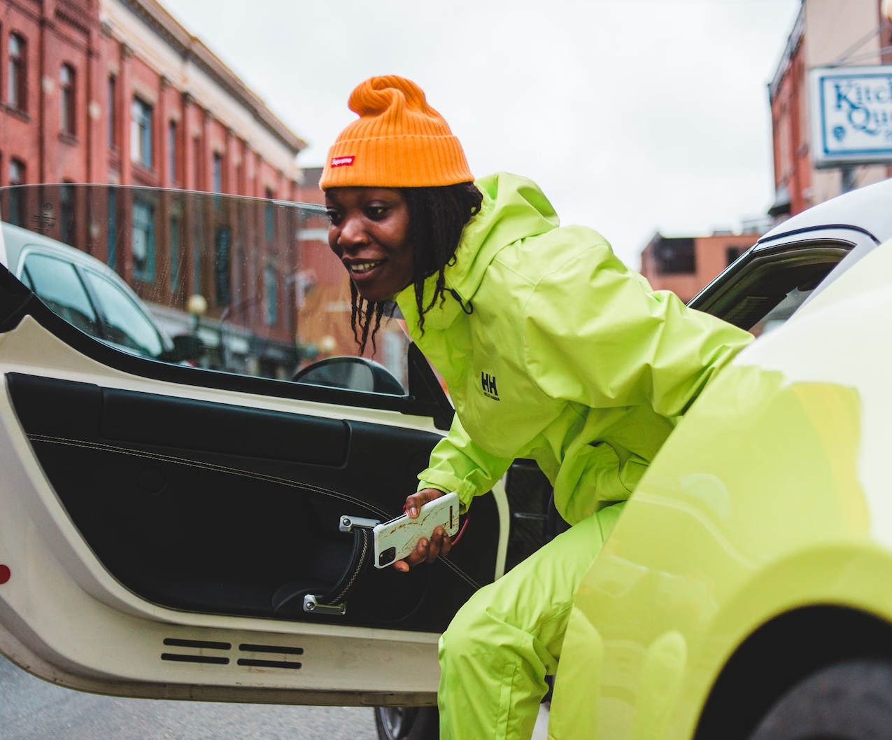 Smiling African-American man getting out of sports car