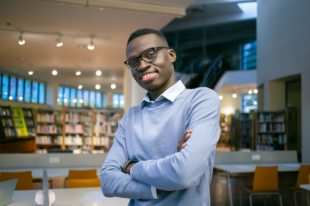 Smiling black man at library.