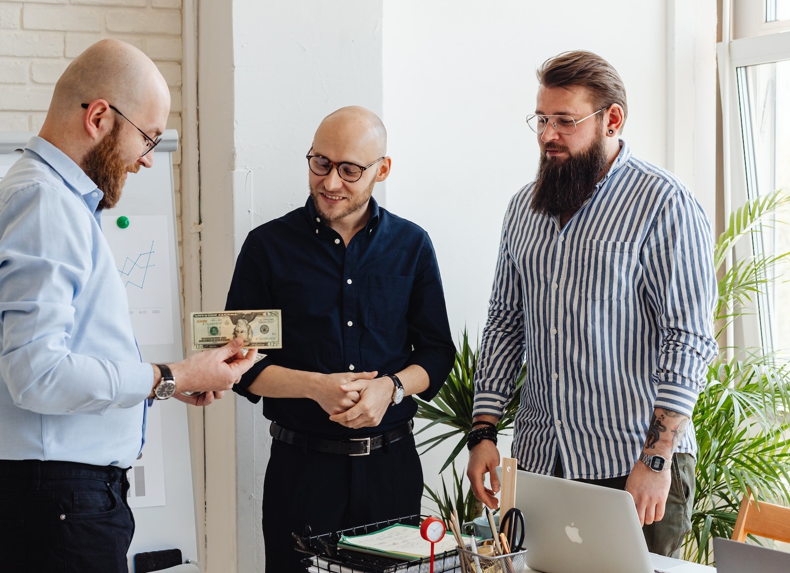 People talking and holding money