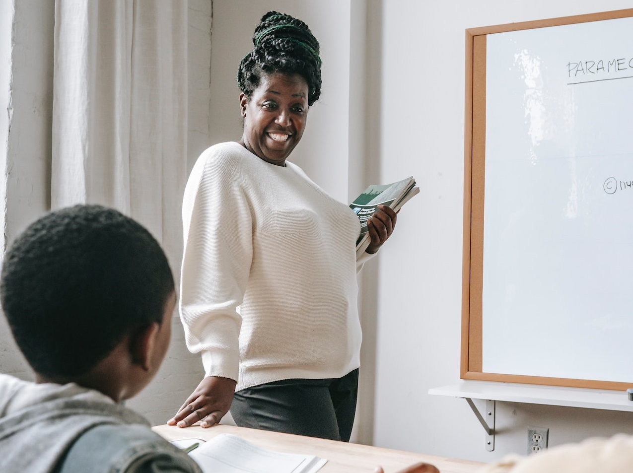 Teacher talking to a kid.
