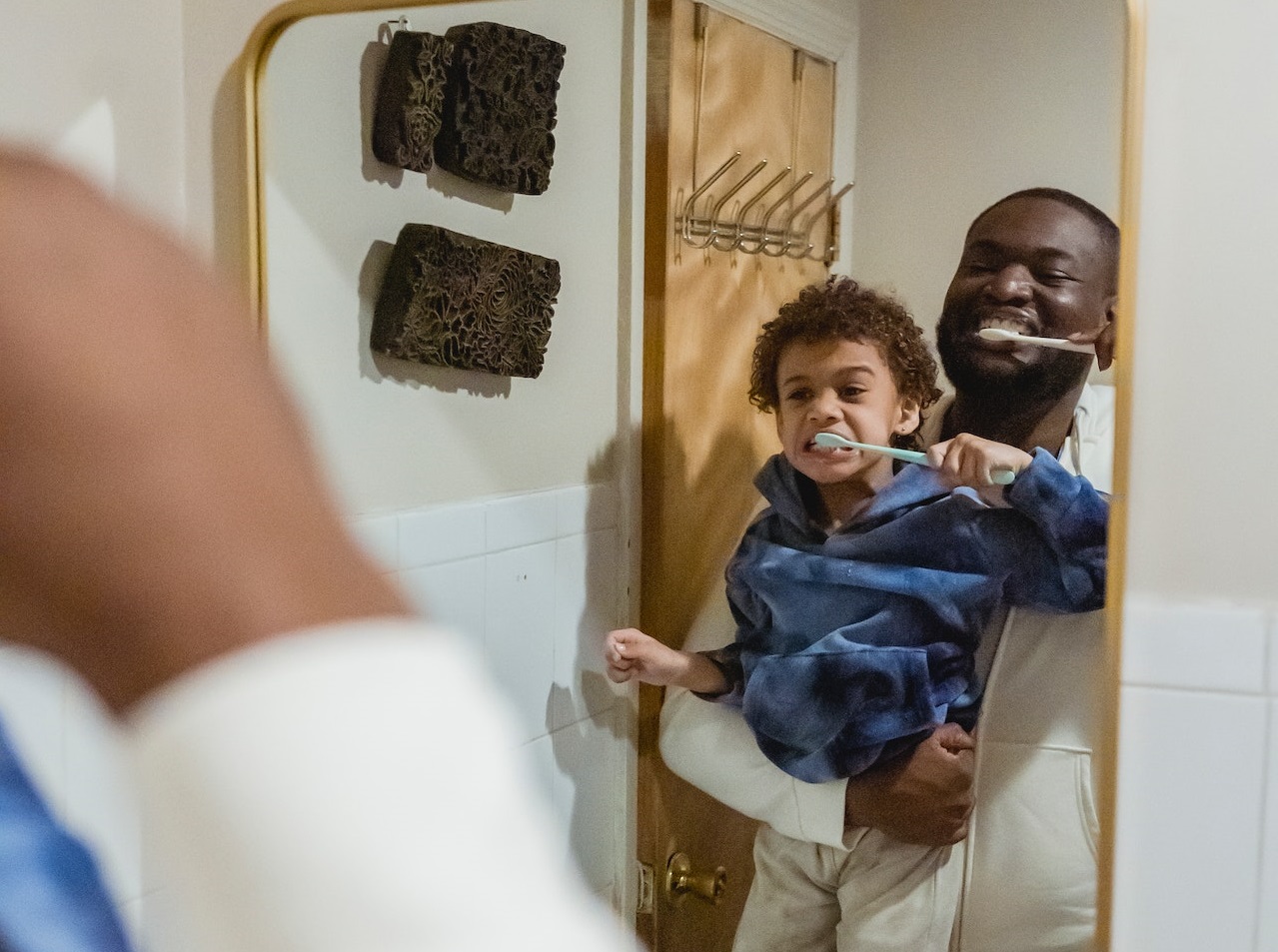 father and son brushing teeth