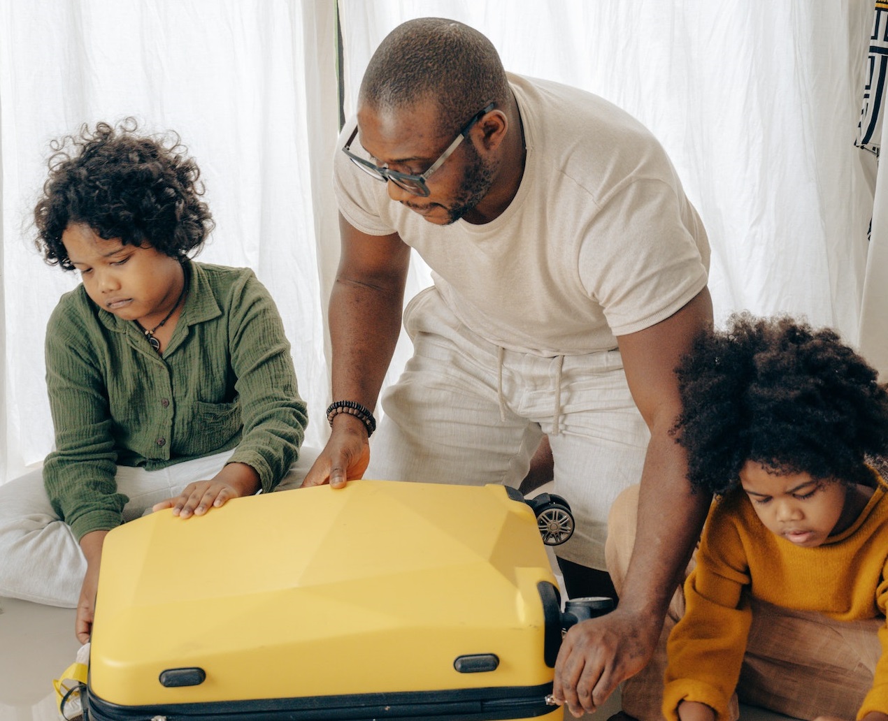 Father and kids packing suitcase