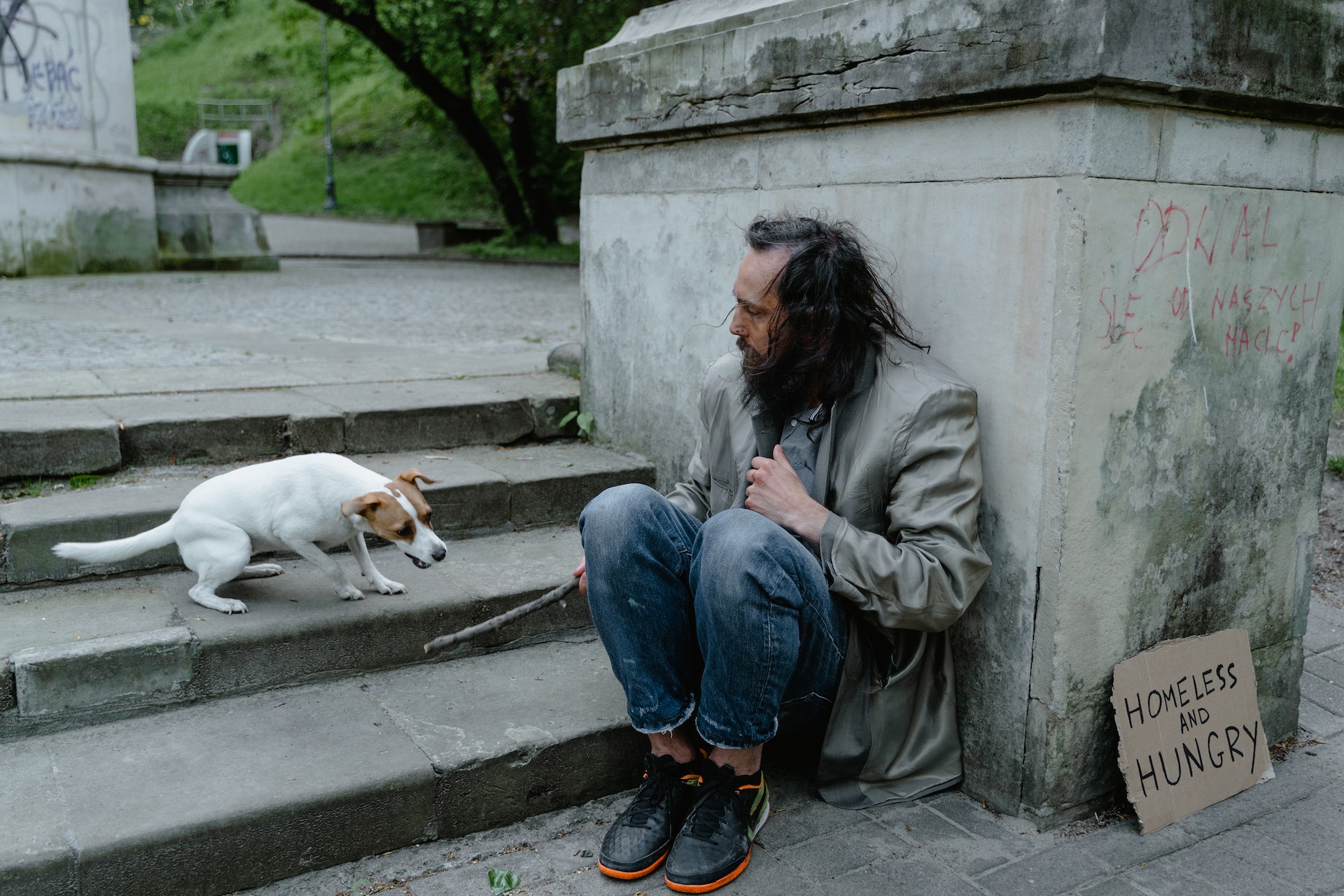 Homeless man sitting on a stairs