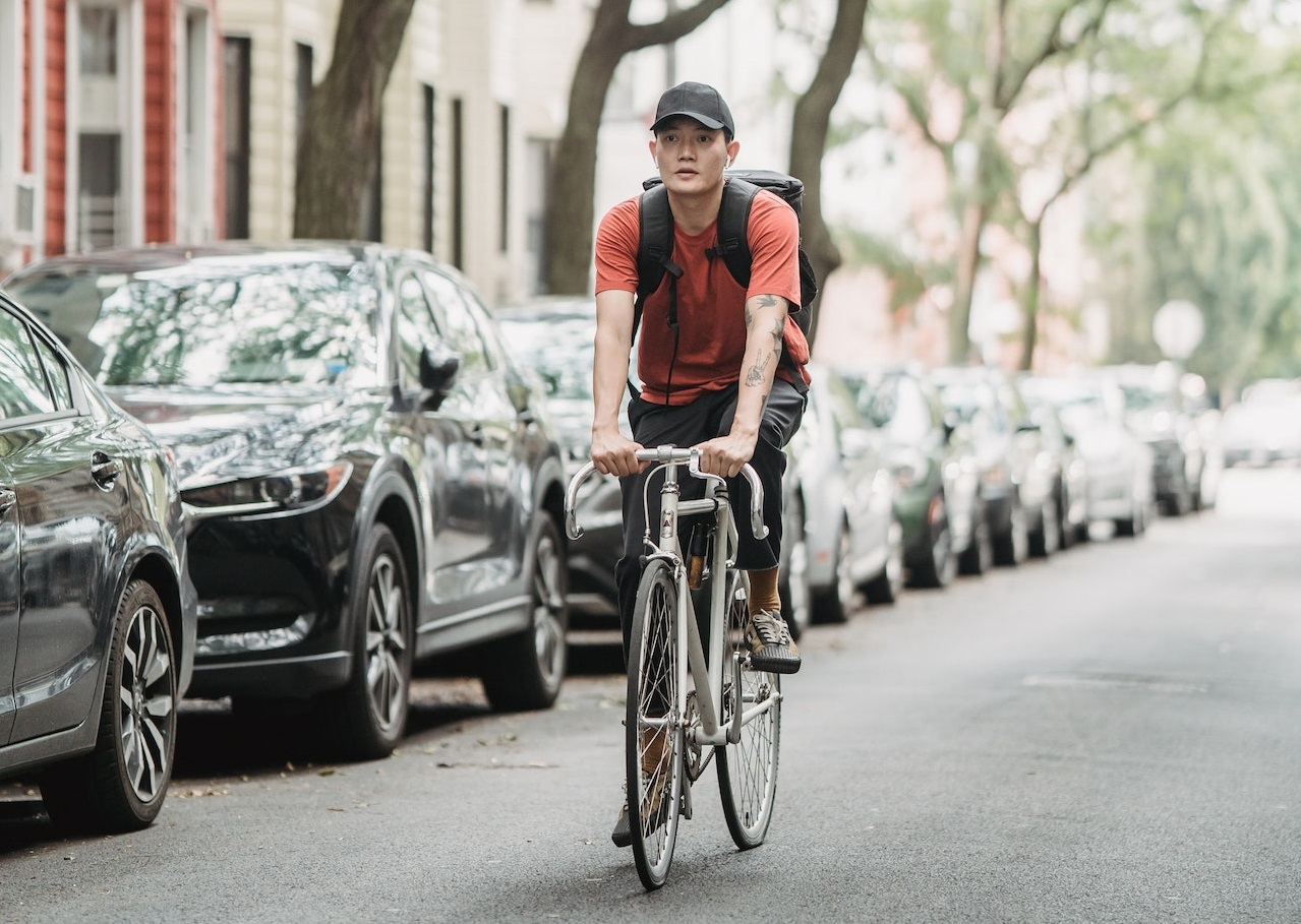 Man driving bike at city street.