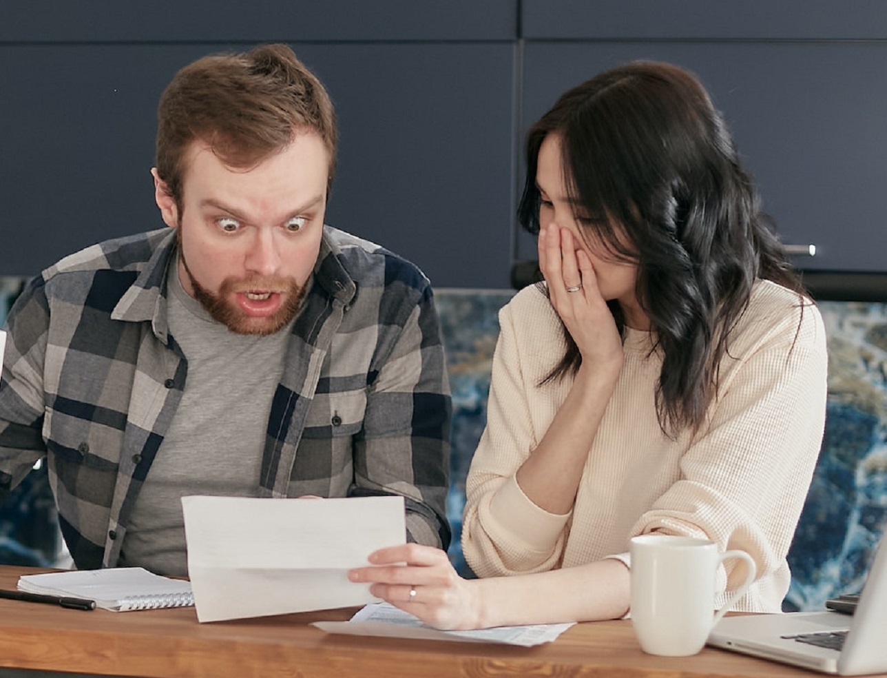 Shocked couple looking at the document