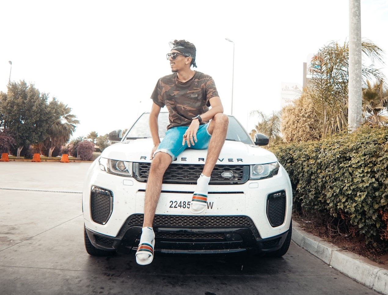 Man is seating in a white Range Rover