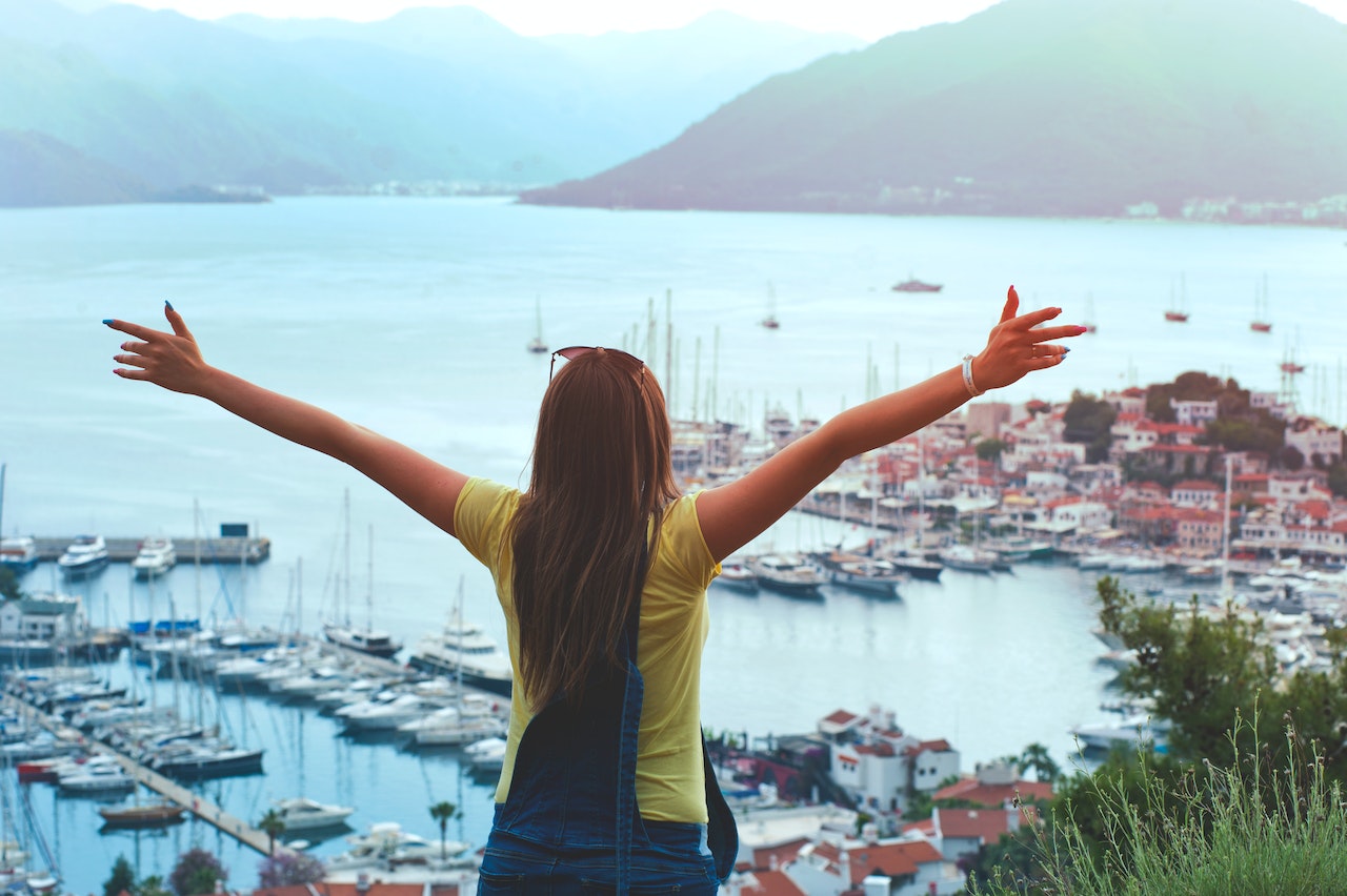 Girl in yellow shirt and jeans enjoying the view.