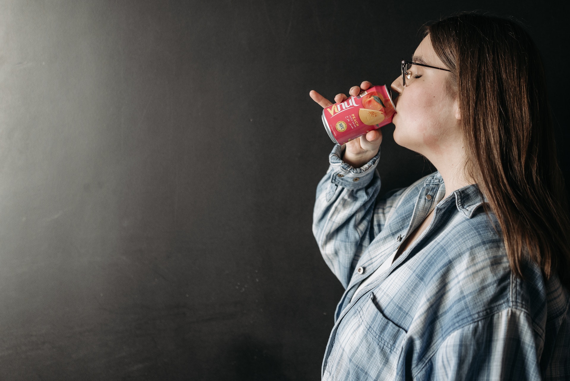 Woman drinking soda can