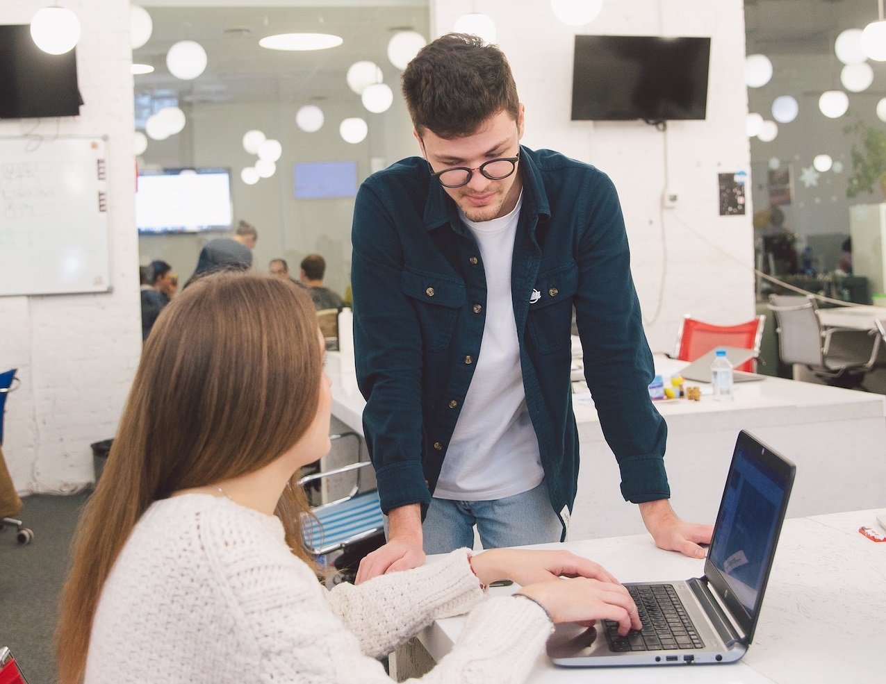 Man talking to woman in office.