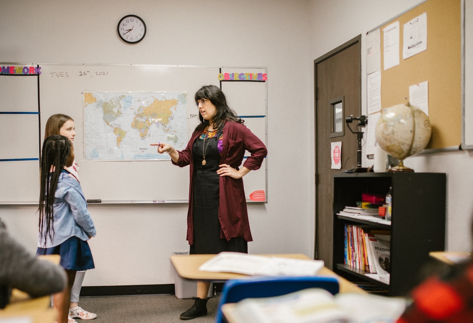 Woman Teacher talking with girls.