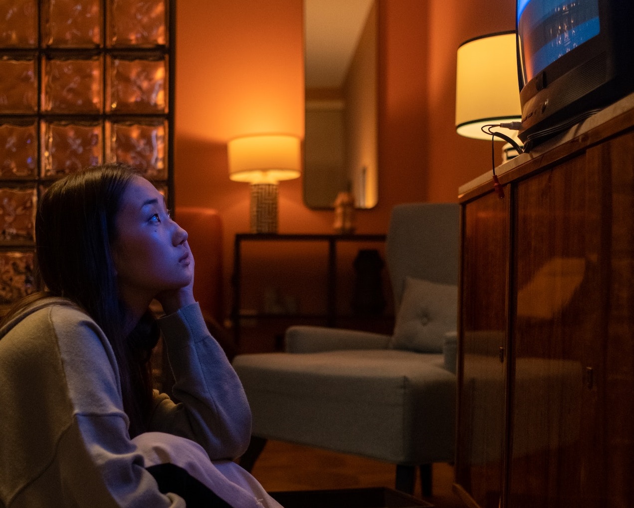 Sad girl watching TV