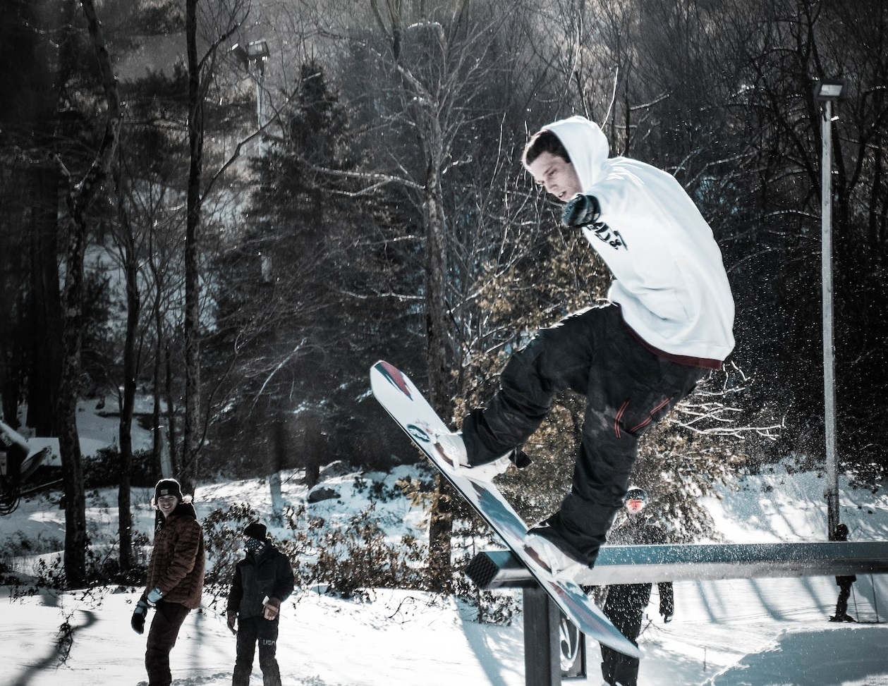 Man on a snowboard outside.