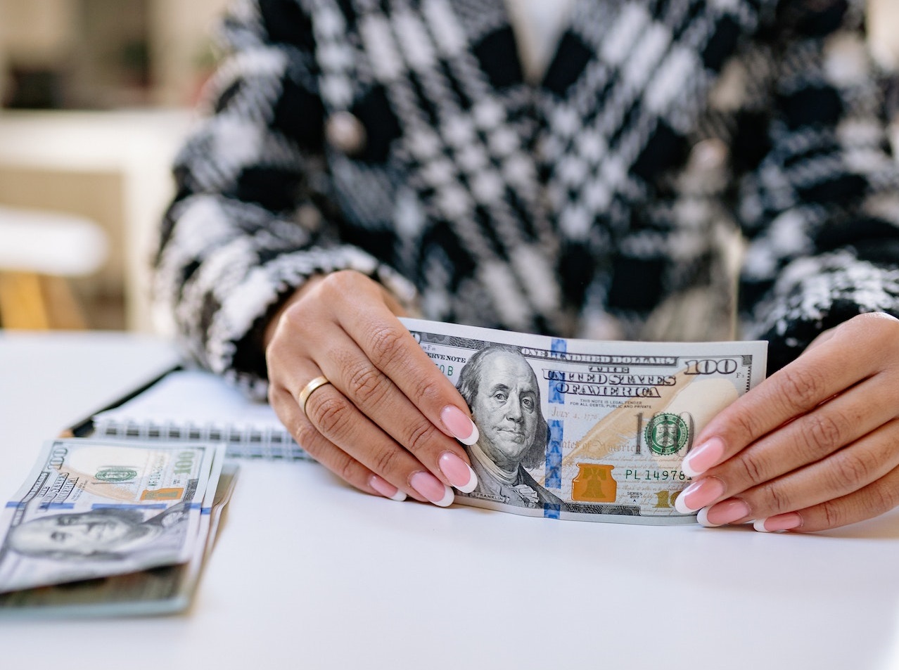 Woman holding a bill in her hands.