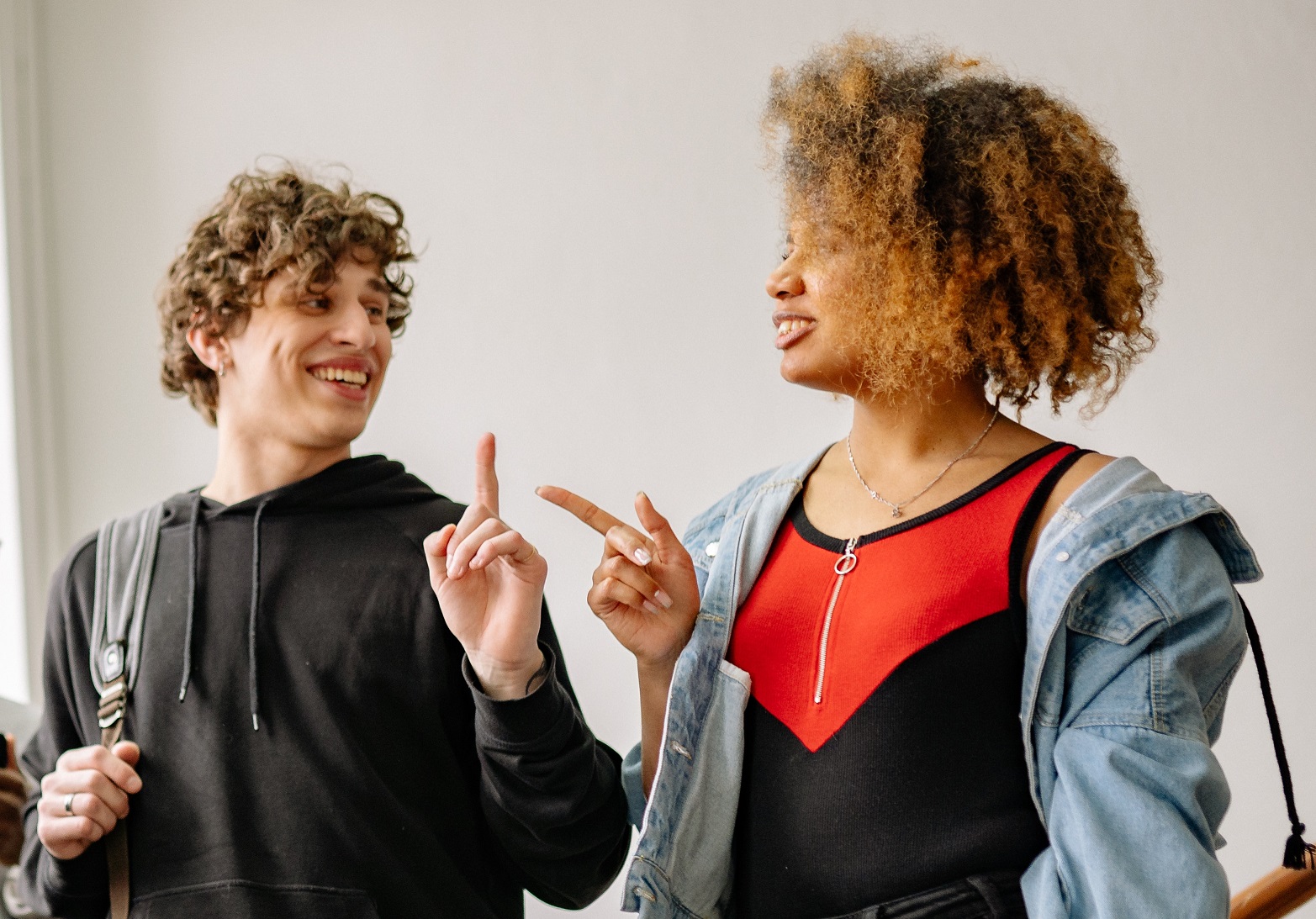 Students talking and pointing to each other.