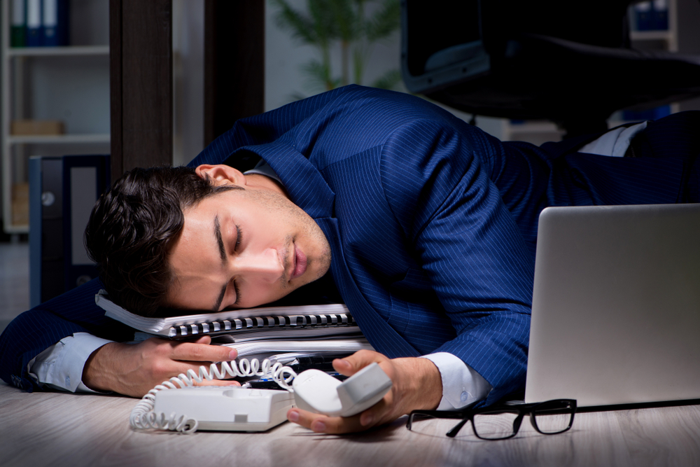 Man in suit sleeping in office