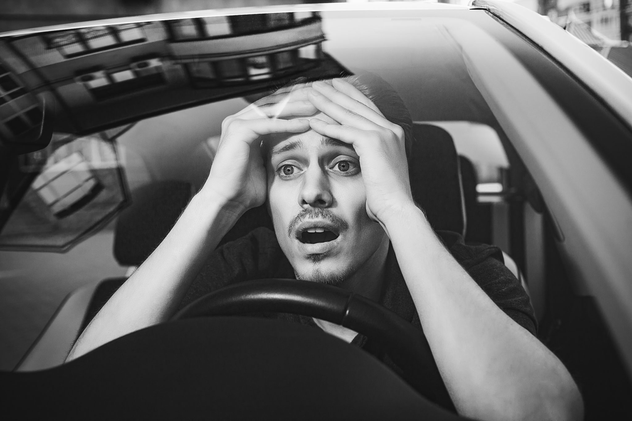 Shocked young man driving a car