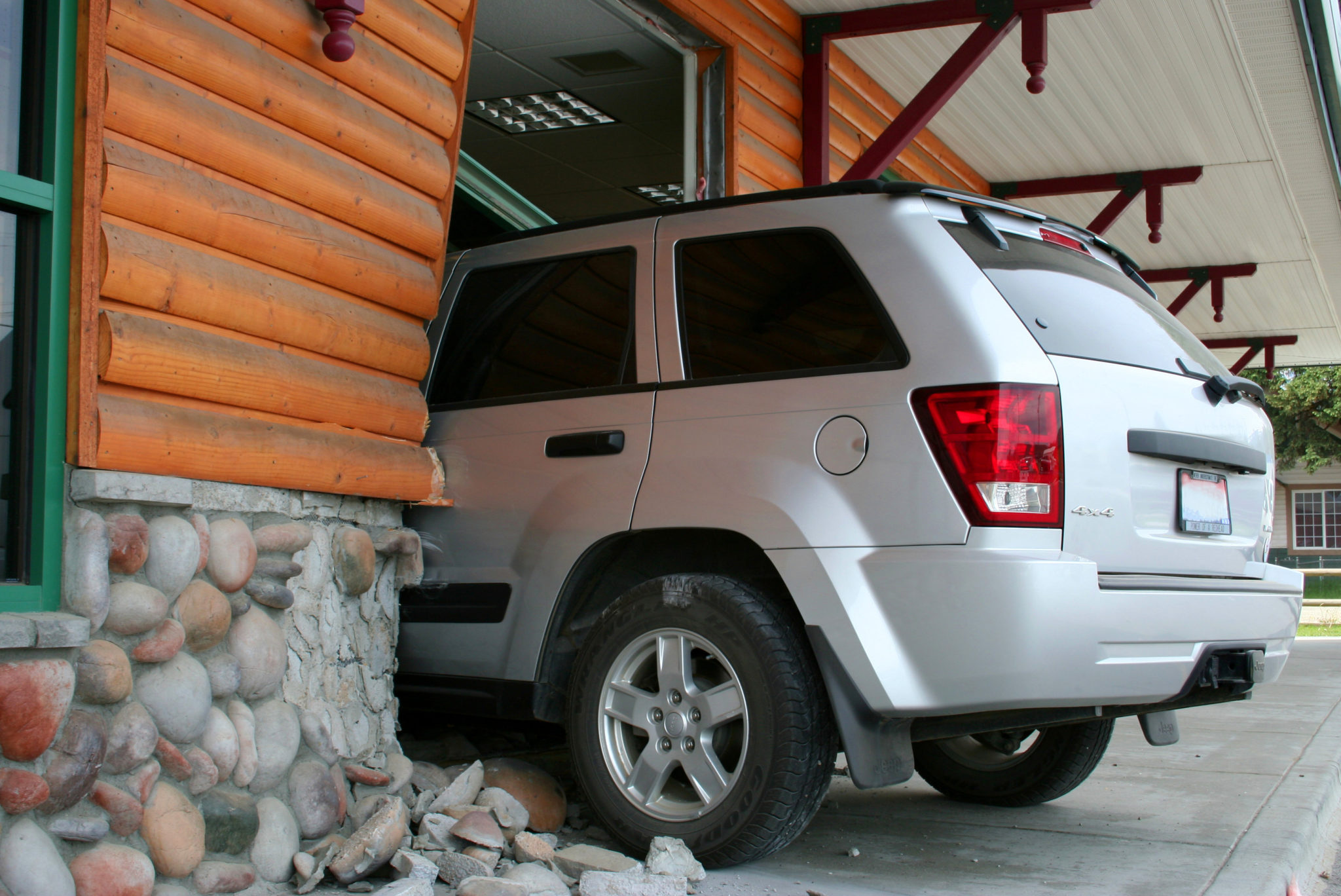 Silver Jeep gone thru the house wall inside.