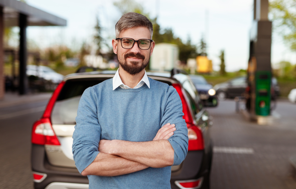 Adult man in casual outfit at gas station