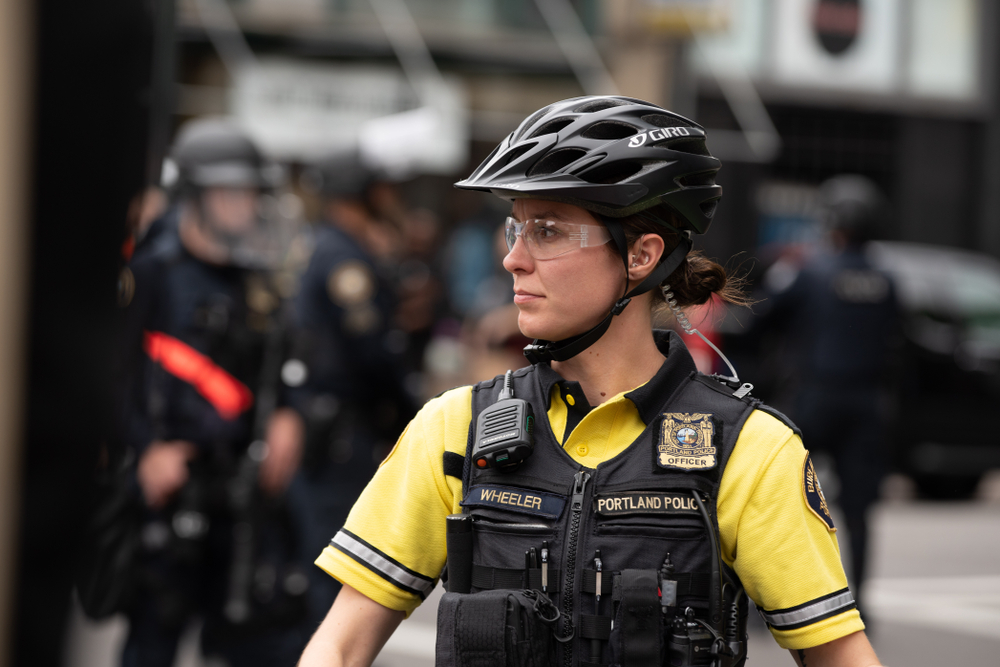 Attractive female police officer wearing bicycle helme