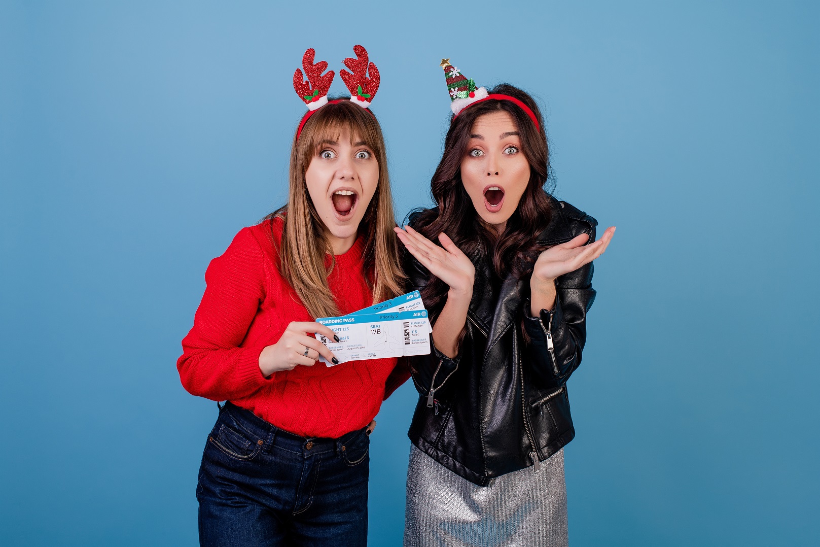Two woman feeling happy and holding a plane tickets