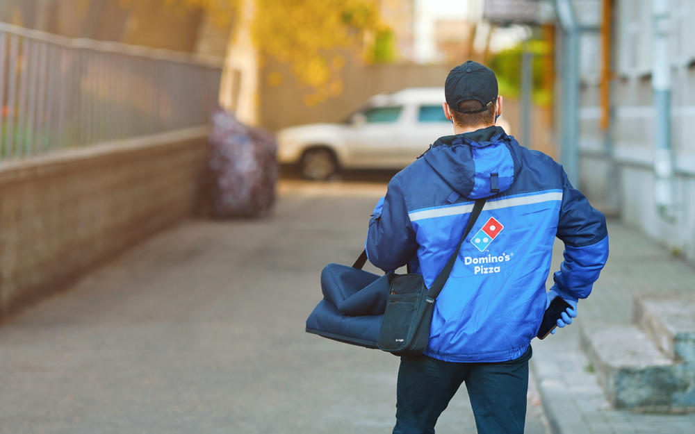 Pizza delivery man in blue uniform and a hat